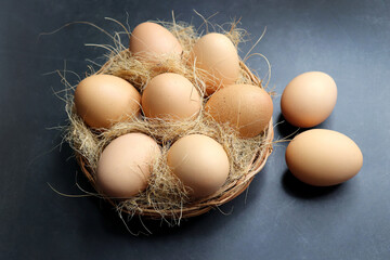 Beautiful white Chicken eggs in a wooden basket. Hen eggs. brown Chicken Eggs online shopping product photography. copy space.