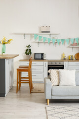 Interior of kitchen with Easter decor, counters and sofa