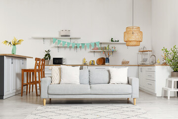 Interior of kitchen with Easter decor, counters and sofa