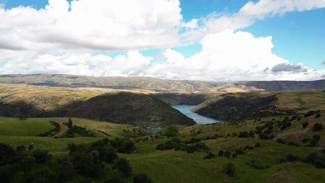 Idyllic rolling landscape of pastures by Clutha River, Otago region New Zealand, aerial view