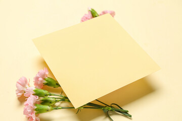 Composition with blank card and carnation flowers on color background, closeup