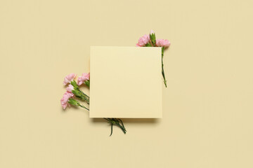 Composition with blank card and carnation flowers on color background