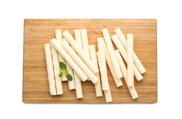 Board with delicious wafer rolls and mint isolated on white background