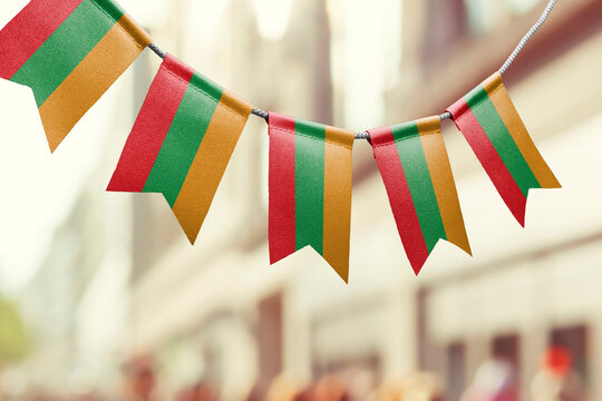 A garland of Lithuania national flags on an abstract blurred background