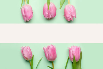 Blank greeting card and beautiful tulip flowers on green background