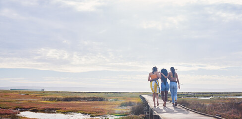 Relax, happy and boardwalk with friends at beach for travel vacation, support or summer break with sky mockup. Diversity, holiday and nature with women walking together for bonding, hug or peace
