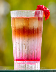 Cocktail with strawberries in nature.