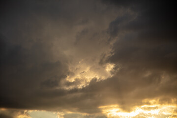 Fototapeta premium Thunderclouds in the sky at sunset.