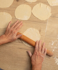 Rolling out the dough with your hands.