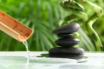 Foto op Plexiglas Spa Stack of spa stones in water outdoors