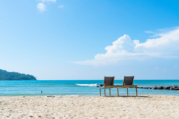 Fototapeta na wymiar sun loungers chair on beautiful beach in Koh Kood island at Trat Thailand. blue sea and cloud on sky background