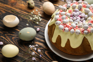 Fototapeta na wymiar Composition with tasty Easter cake, eggs and gypsophila flowers on wooden background, closeup