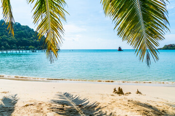 Fototapeta na wymiar Beautiful beach with green palm tree in Koh Kood island at Trat Thailand. blue sea and sky background