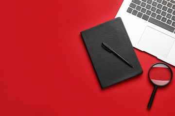 Book, pen, magnifier and laptop on red background. World Poetry Day celebration
