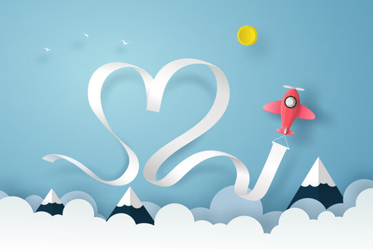 Plane flying on the blue sky over the clouds and mountain with smoke, heart ribbon in vector paper art concept