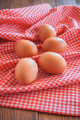 chicken eggs on pink classic tablecloth with selective focus