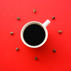 white coffee cup on red background with Coffee beans arrange as forming clock face.