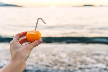 Citrus fruit with paper tube on sunset background