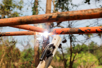 Welding steel that produces smoke and sparks.