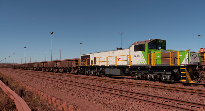 Saldanha Bay, west coast, South Africa. 2023. Locomotive hauling iron ore cargo in railway trucks through Saldanha Port  for export.