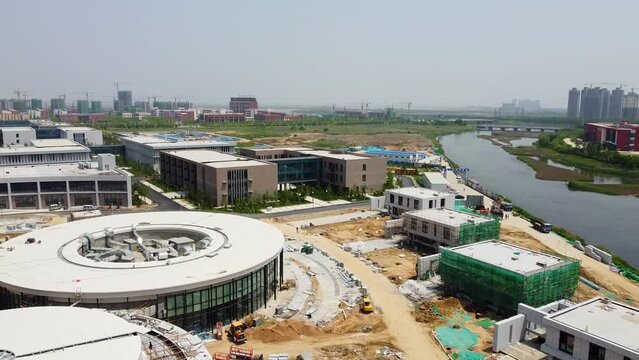 Weihai Olympic center hotel section construction aerial forward rotating dolly - Nanhai New District, China.
