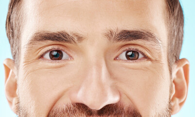 Skincare, vision and zoom on man eyes, beauty and grooming portrait isolated on blue background. Eye care, health and facial wellness, good eyesight and glowing skin on happy male model in studio.