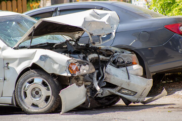 Two cars on the road after a collision. Road adventure and broken bumper, hood, headlights and...