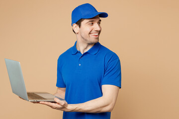 Delivery guy employee IT man wear blue cap t-shirt uniform workwear work as dealer courier hold use...