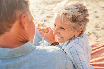 Champagne, senior beach couple laughing and love with mature care and support of marriage. Toast, wine and sea picnic of a old man and woman together on holiday in summer loving the sunshine outdoor