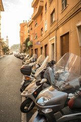 Fototapeta na wymiar Many Motorcycles in a Row in City of Genoa, Liguria in Italy.