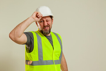 worker in a vest and white helmet