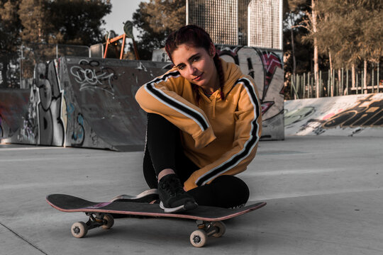 Young woman with street clothes on a skating rink