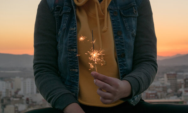Amazing festive sparklers in the hands of a young woman
