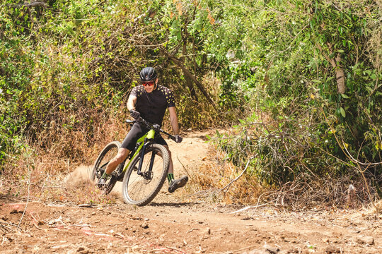 Action photo of male mountain bike cyclist on trail