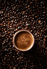 Cup of coffee and dark roasted coffee beans