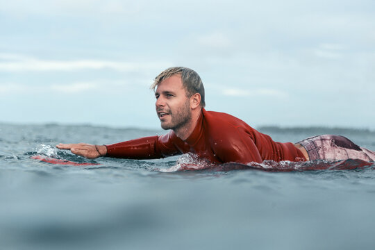 Man lying on surfboard on the sea
