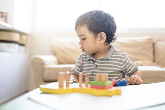 Child with educational logic toys in the living room