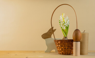 Easter decoration - a figure of a wooden hare, an egg and a white hyacinth