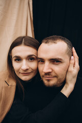 a close-up photo of the eyes of a man and a woman of brown color. a man and a woman leaned their faces together