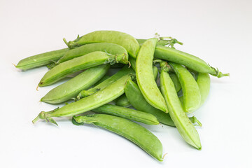 Green peas on a white background. Pea pods on a white background.