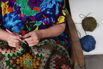 Fototapeta na wymiar Woman crochets from threads. Close up hand with crochet hook