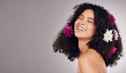 Black woman, beauty and smile with flower hair in cosmetics or skincare against a gray studio background. Happy African American female model smiling in joyful satisfaction for floral art on mockup