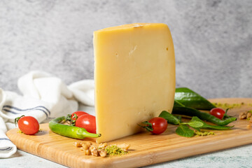 Old cheddar cheese. Traditional Old Sliced Turkish Kars Old Cheddar Cheese on a wooden serving board. Dairy products