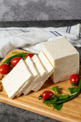 Ripe white cheese. Feta cheese made from cow's milk on a wooden serving board. Dairy products