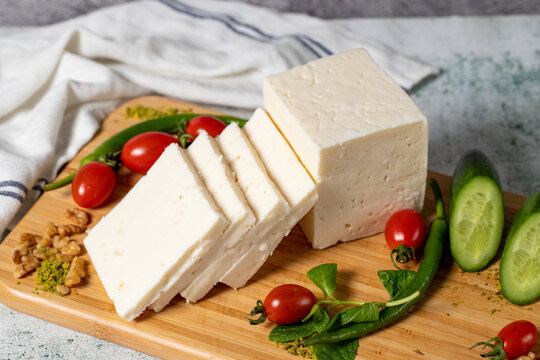 Ripe white cheese. Feta cheese made from cow's milk on a wooden serving board. Dairy products