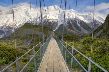 View of a snow-capped mountain with a swing bridge in the foreground Mount Sefton Aoraki Mount Cook National Park South Island New Zealand