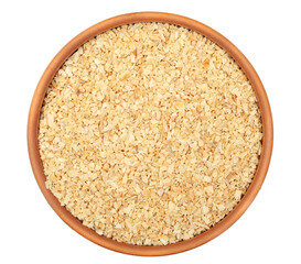 Chopped dry garlic pile in clay pot isolated on white, top view