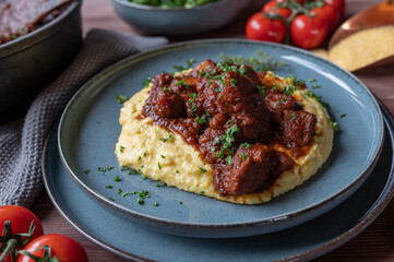 Pork ragout with creamy polenta on a plate