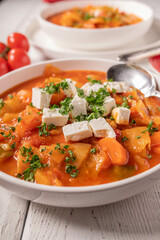 Vegetable soup with cabbage and feta cheese on a plate