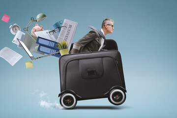 Businessman riding a briefcase with wheels